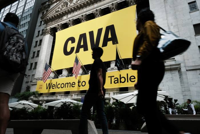 A sign for Mediterranean restaurant chain Cava is displayed outside the New York Stock Exchange 