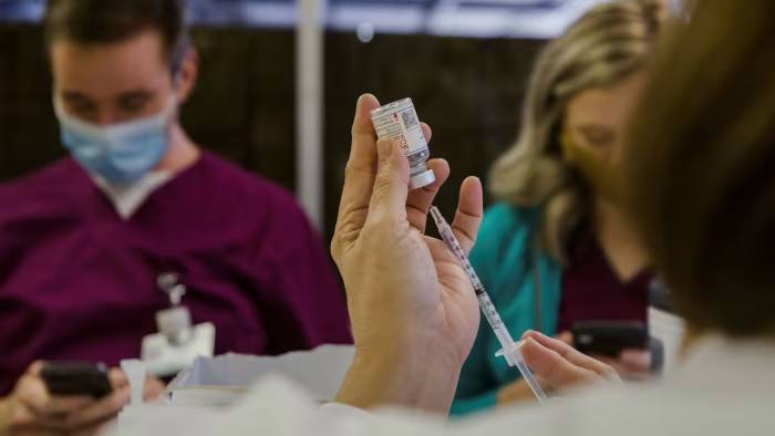 People prepare to receive a Covid vaccine 