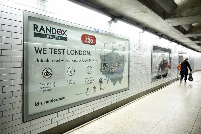 An advertisement for Randox Covid-19 testing services is seen in an underground station in November last year in London, England