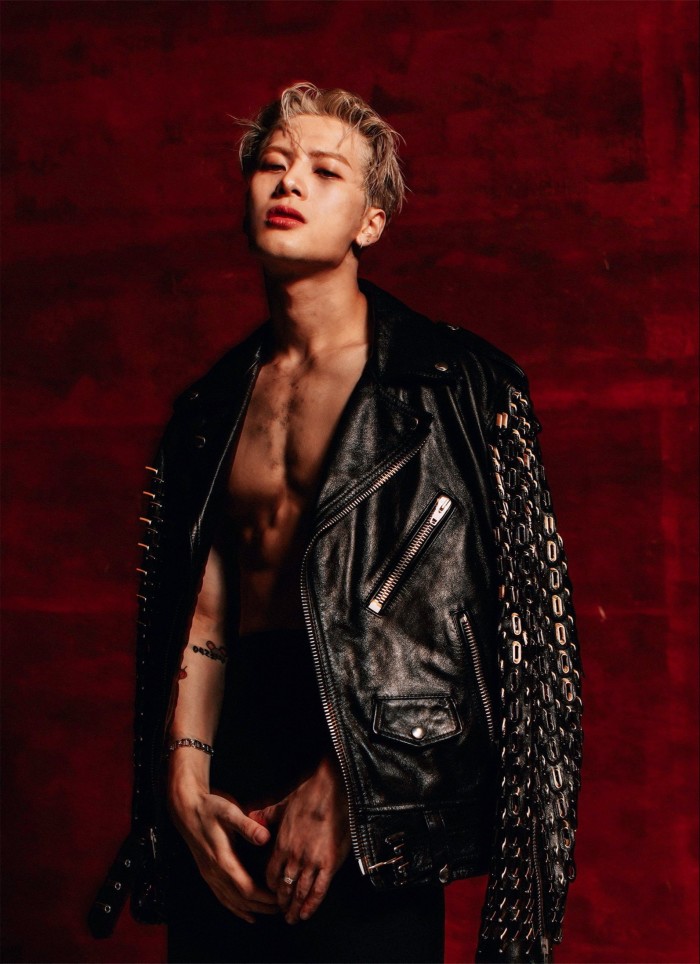 Chinese pop star Jackson Wang poses in a black leather biker jacket worn over a bare chest