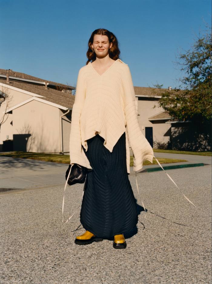 Acne Studios cotton jumper, POA. Issey Miyake polyester Wrapped Pleats trousers, £955. Bottega Veneta leather Intreccio bag, £2,800. Peter Do leather boots, £765. Earrings, stylist’s own