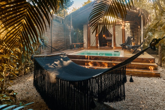 A hammock by the pool at Habitas Tulum