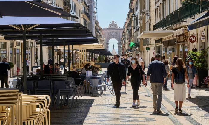The collapse of tourism has been dramatic: Lisbon’s Rua Augusta this month and, below, before the pandemic