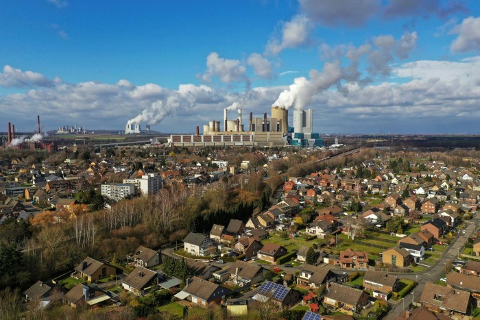 A residential suburb in Oberaussem, Germany, with an RWE power station pumping out smoke on the horizon
