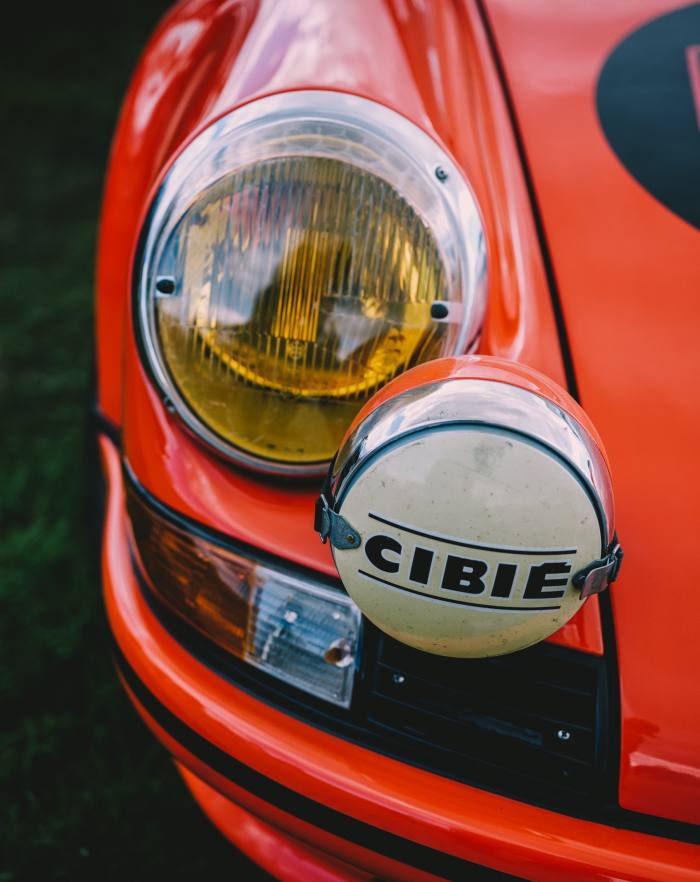 A Porsche 911 with Cibié hood lights