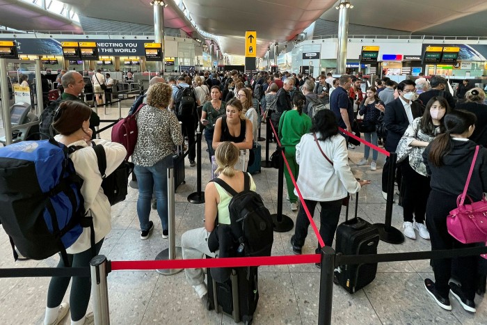 Travelers queue for security checks at London Heathrow Airport on Wednesday.