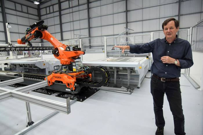 Mike Abelson, head of UK electric van and bus maker Arrival’s North American operations, shows a production robot at the start-up’s  ‘microfactory’ in Bicester