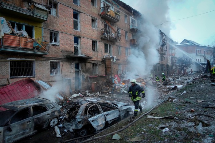 Ukrainian firefighters work to extinguish a fire at the scene of a Russian shelling in the town of Vyshgorod, north of Kyiv