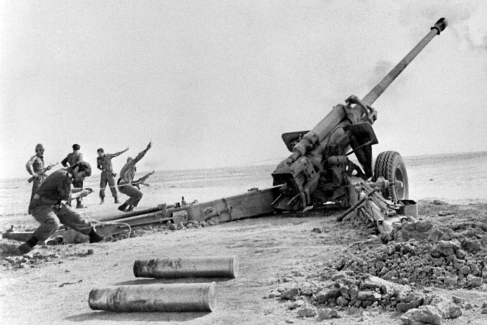 Soldiers firing artillery shells