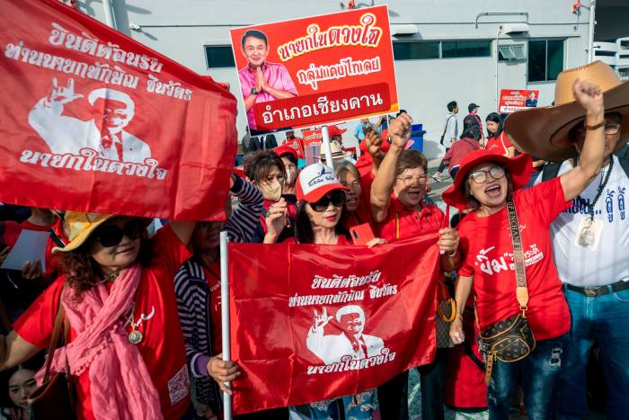 Supporters of former Thai Prime Minister Thaksin Shinawatra waited outside Bangkok's Don Muang Airport for his arrival on Tuesday