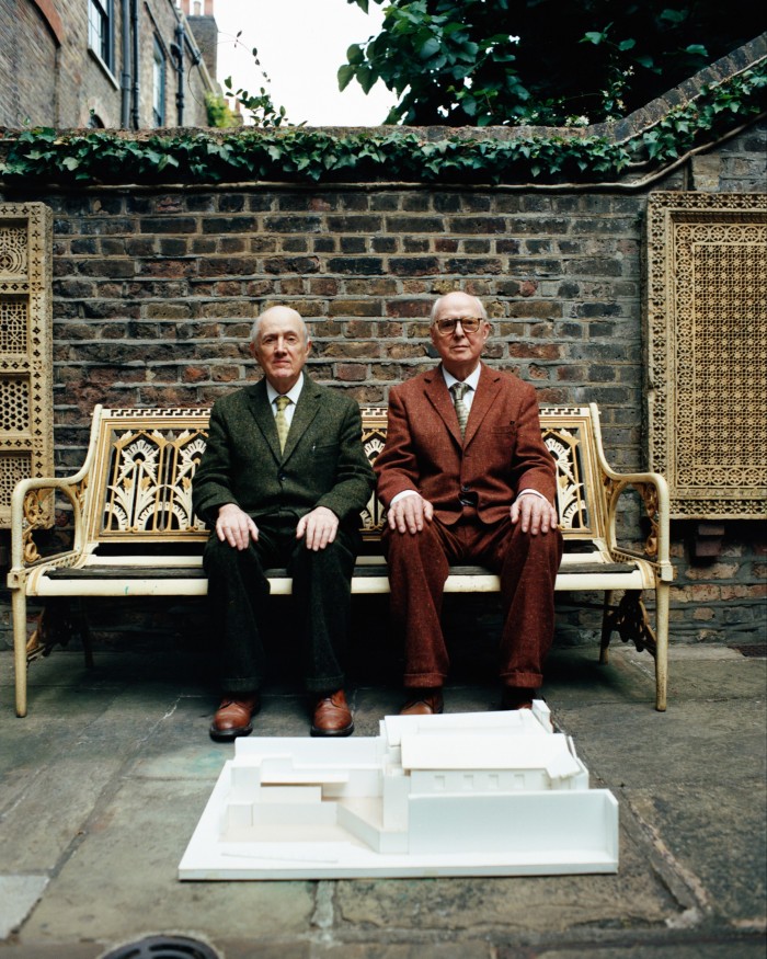 Gilbert Proesch (left) and George Passmore with a model of The Gilbert & George Centre