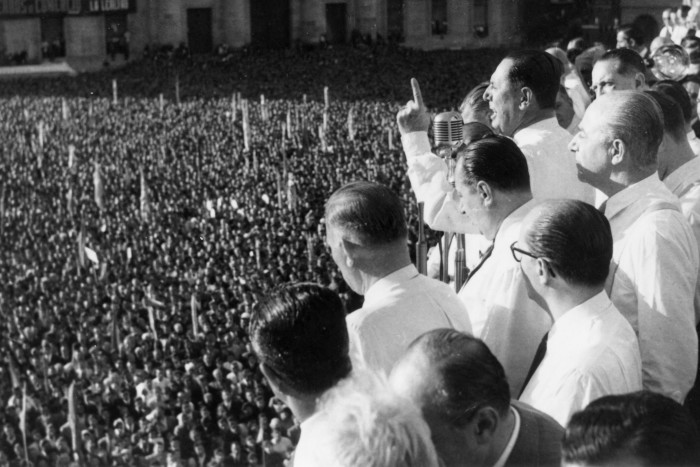 A black-and-white photo dated circa 1950 of Argentina’s Juan Peron addressing a huge crowd from a balcony