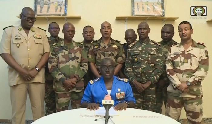 Soldiers flank a spokesperson for the self-proclaimed National Committee for the Salvation of the People in a televised statement on July 26 claiming to have overthrown the government of Mohamed Bazoum
