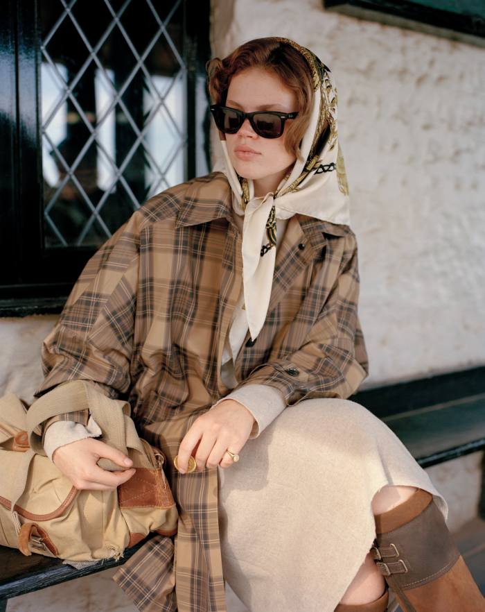 Totême recycled polyester coat, £1,290.  Chloé recycled cashmere dress, £1,320.  Vintage Hermès silk scarf, £198, resee.com.  Ariat leather and recycled rubber boots, £230.  Ray-Ban vintage Wayfarer sunglasses, £67.68, cloakroomcollective.com.  Vintage Billingham camera bag, belonging to the photographer