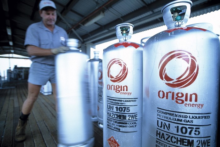 A worker stacks cylinders of compressed liquefied petroleum gas at Origin Energy’s BassGas processing plant at Lang Lang in Victoria’s Gippsland region 