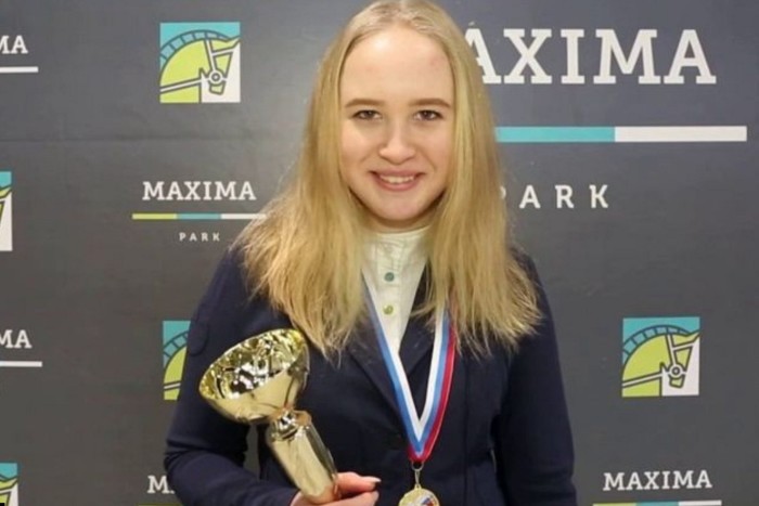 Veronika Prigozhina pictured with a trophy in her hand and medal round her neck after a showjumping competition