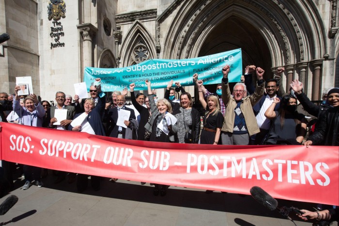 Postmasters celebrate outside the High Court after their convictions were quashed