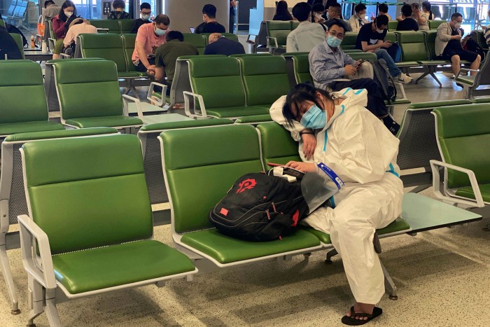 A person sleeping at a boarding gate at Shanghai Hongqiao International Airport 