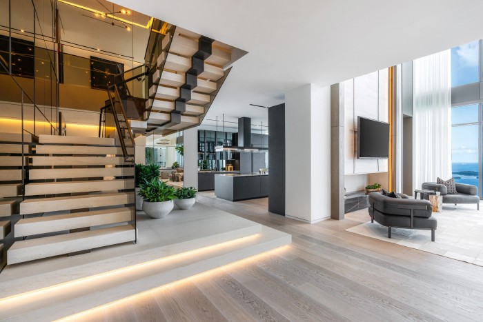 The staircase, living space and kitchen of the Brickell Avenue condo