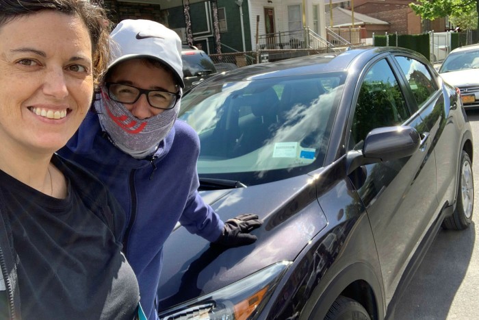 Rebecca Coleman, right, and her wife Nicole in New York with their new car, which they bought online without visiting a forecourt, or taking a test drive