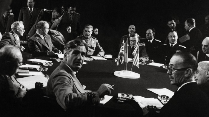 Historical black and white photo of allied leaders at the Potsdam conference in 1945