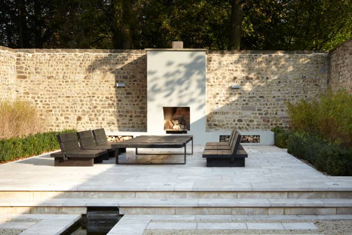 An outdoor living space with a fireplace that was recently created by Fiona Barratt-Campbell 