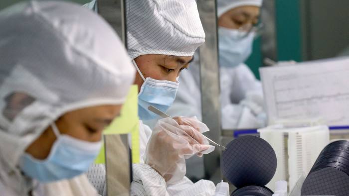 Employees make chips at a factory of Jiejie Semiconductor Co in China’s eastern Jiangsu province 
