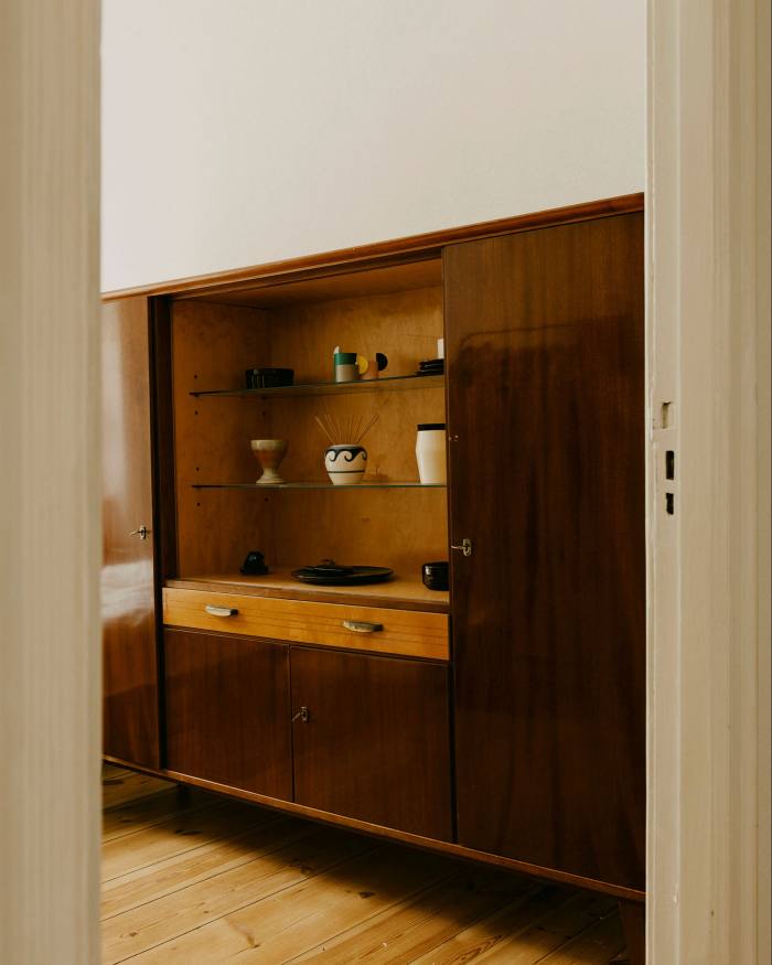 GDR-era wardrobe with brass handles and glass shelves (€190)
