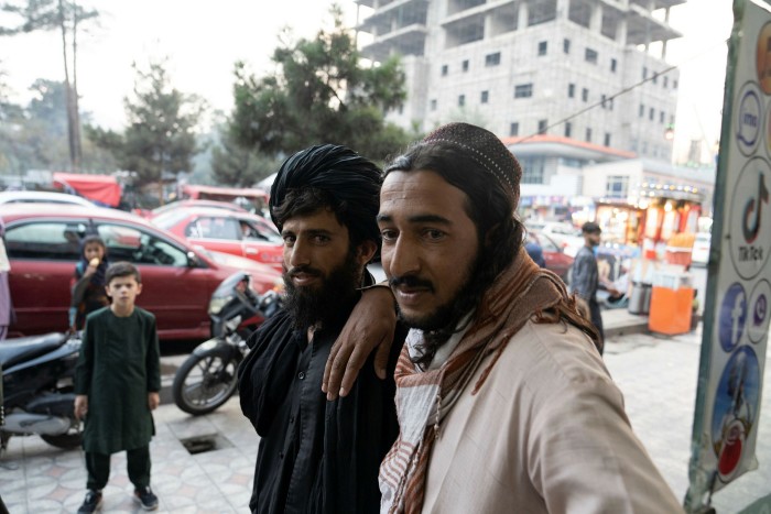 Taliban soldiers outside a mobile phone shop in Kabul