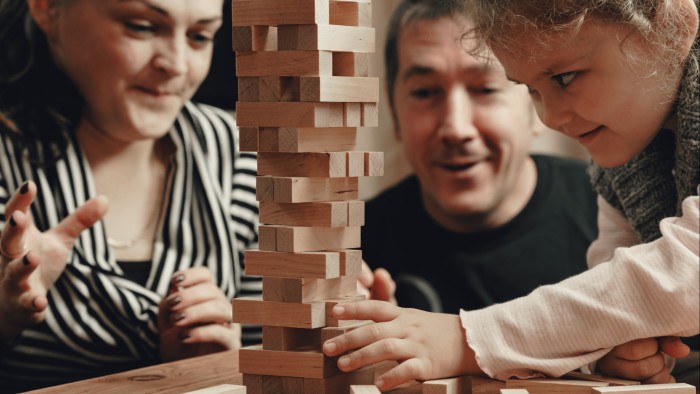 A family playing the game Jenga