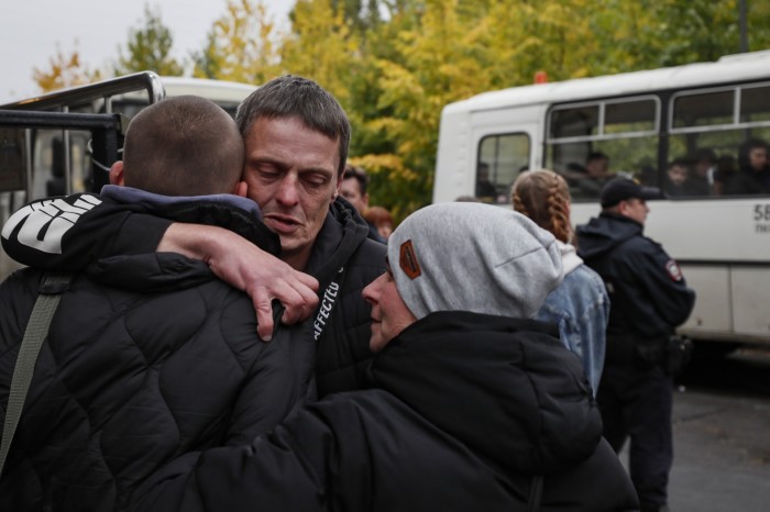 Conscripted Russians say goodbye to relatives at a recruitment office in Moscow in September
