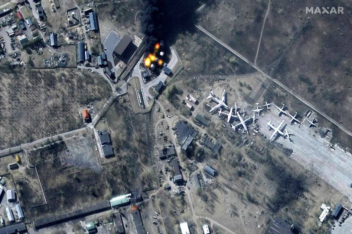 A satellite image of damaged buildings and burning fuel storage tanks at Hostomel Airport north of Kyiv on March 11.