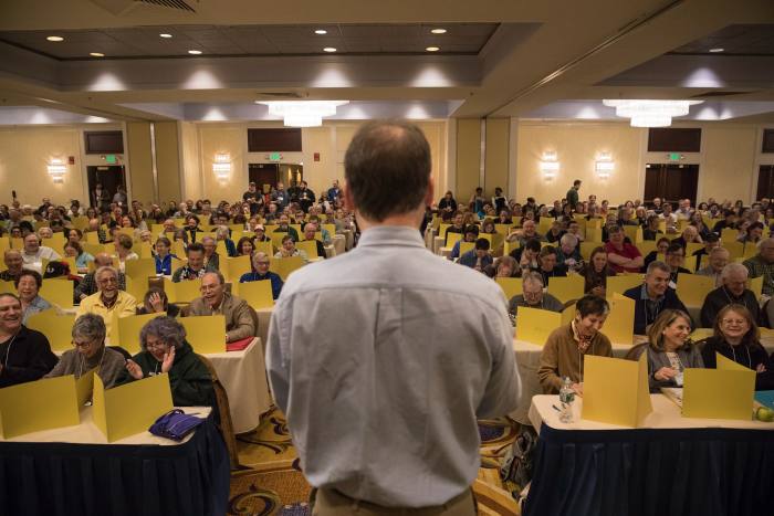 Will Shortz, The New York Times’s crossword editor, speaks to the crowd at the 2018 American Crossword Puzzle Tournament in Stamford, Conn., March 25, 2018