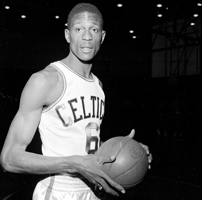 Bill Russell wears a Boston Celtics uniform for his first workout with the NBA team shortly after signing a contract in December 1956