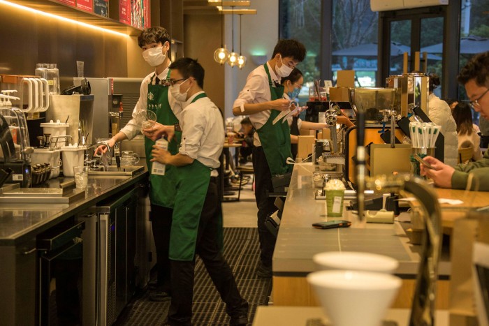 Employees at a Starbucks store in China. Luckin now has about 500 more outlets across the country than the US chain