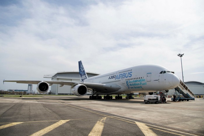 A380 Airbus on a runway with the words ‘100% Sustainable Aviation Fuel on board’ painted on its side