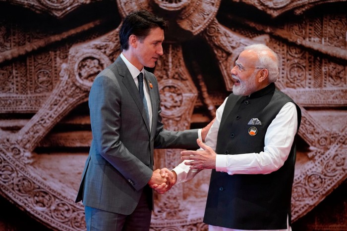 Justin Trudeau and Narendra Modi shaking hands