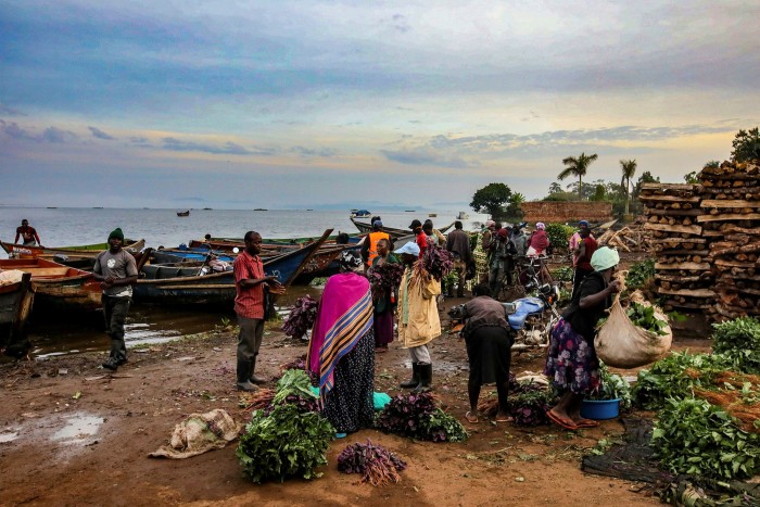 Locals gather on the shore of Albert Lake in Murchison Falls National Park, Uganda