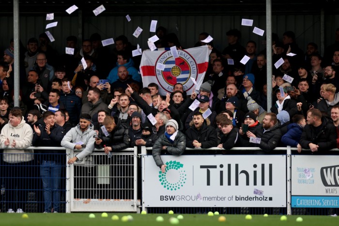 Reading fans throw fake money, tennis balls and flares on to the pitch