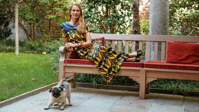 JJ Martin on a bench in a garden with her dog Pepper