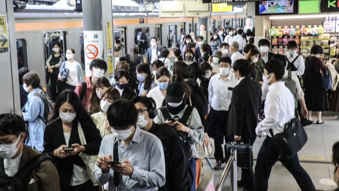 Japanese citizens wearing masks in a subway