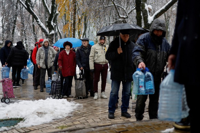 Ukrainians carrying empty water bottles