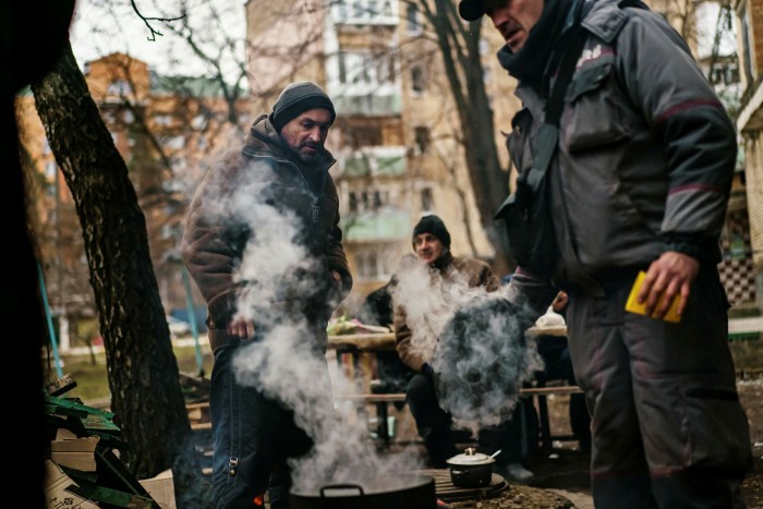 Irpin residents on the edge of town and close to the front line, gather to keep warm and make a communal meal.