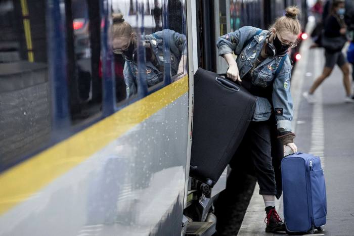 A passenger gets off a Eurostar train in Amsterdam