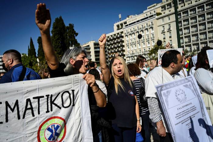 Health workers and demonstrators protest outside the Greek parliament in Athens on November 3, 2021, against Covid-19 mandatory vaccines. (Photo by Aris Messinis / AFP) (Photo by ARIS MESSINIS/AFP via Getty Images)