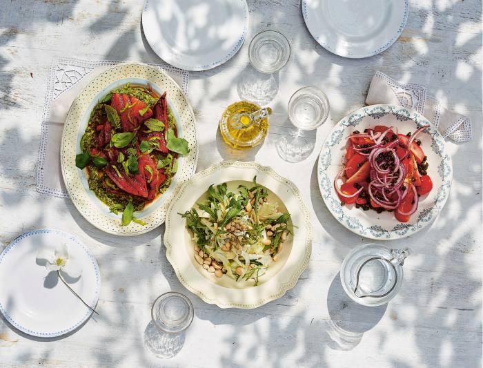 From left: charred watermelon with pistachios;  fennel, pear and almond salad;  and village-style tomatoes with crunchy capers, all from Nistisima by Georgina Hayden