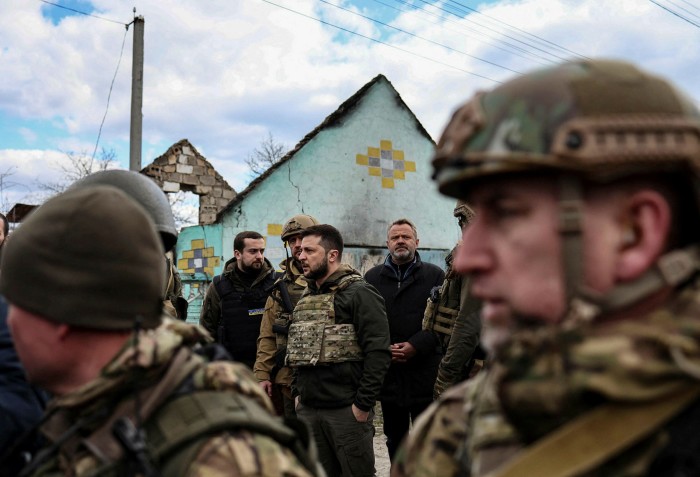 President Volodymyr Zelensky and Ukrainian military walk through the city of Bucha on April 4