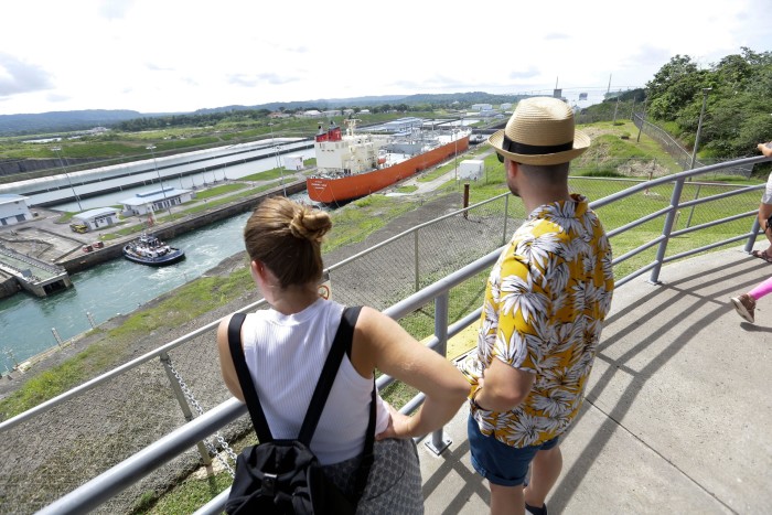 Tourists observe the Agua Clara locks in the Panama Canal