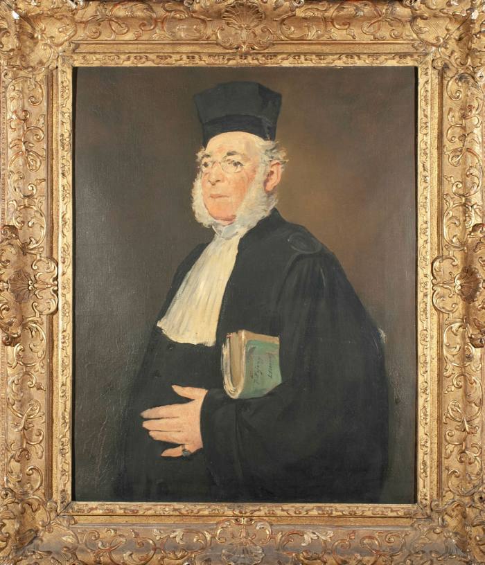 A stern-looking older man in a black robe and hat