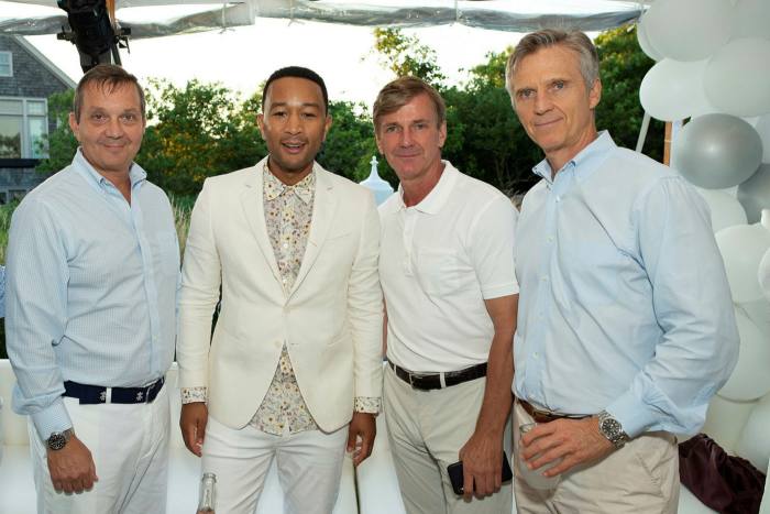 Lew Dickey, right, with the singer John Legend, centre, and others in New York. Backers of Dickey's Modern Media lost their entire investment after the Akazoo scandal